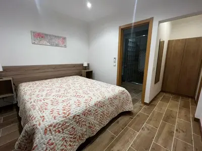 a bedroom with a bed and a wooden floor at Quinta Vita- Vila Laranja in Almancil