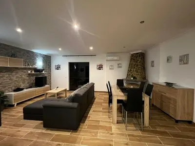 a living room with a couch and a table at Quinta Vita- Vila Laranja in Almancil