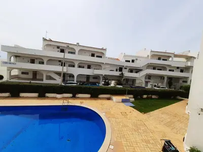 a large building with a swimming pool in front of it at Casa Cerro Sol in Albufeira