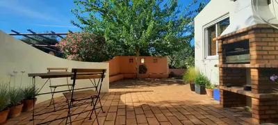 a patio with a table and a tree and a building at Rural Peace in the Algarve - Private Room with kitchenette and bathroom in Aldeia dos Matos