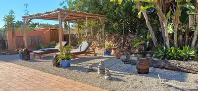 a patio with a swing and some plants at Rural Peace in the Algarve - Private Room with kitchenette and bathroom in Aldeia dos Matos