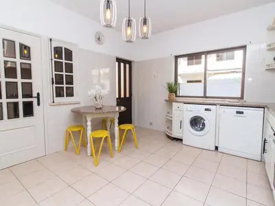 a kitchen with a table and yellow stools at Villa Bel Mar by Stay ici Algarve Holiday Rental in Guia