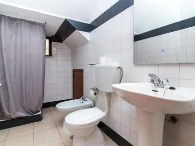 a bathroom with a white toilet and a sink at Villa Bel Mar by Stay ici Algarve Holiday Rental in Guia