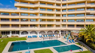 an apartment building with a swimming pool and a hotel at Marina 2BDR Apartment With Balcony & Pool - 5min from beach by LovelyStay in Quarteira
