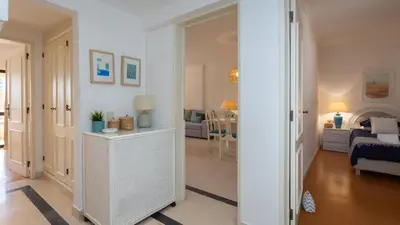 a hallway with a living room and a bedroom at Marina 2BDR Apartment With Balcony & Pool - 5min from beach by LovelyStay in Quarteira