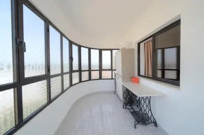 a room with large windows and a white floor at APARTAMENTO TROPICANA in Quarteira