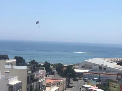 a view of a city with the ocean and buildings at Bmar in Quarteira