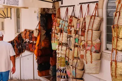 a man standing in a store with baskets on the wall at Old Fisherman's Corner 14 - Centro Old Town Albufeira in Albufeira