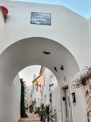 an archway in a building with a sign on it at Old Fisherman's Corner 14 - Centro Old Town Albufeira in Albufeira