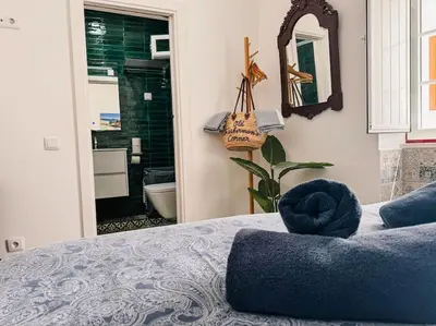 a bedroom with a blue bed and a mirror at Old Fisherman's Corner 14 - Centro Old Town Albufeira in Albufeira
