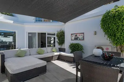 a living room with a couch and a table at Villa Allegra - Quinta do Lago in Almancil
