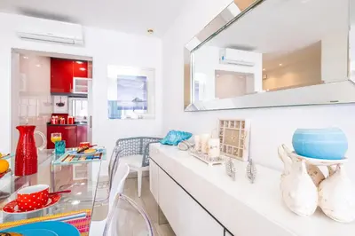 a kitchen with white counters and a table with chairs at Luxurious Seaview Apartment with pool 5min Beach in Albufeira