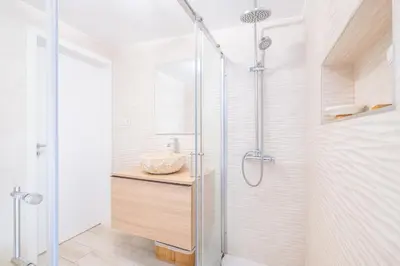a bathroom with a shower with a glass door at Luxurious Seaview Apartment with pool 5min Beach in Albufeira