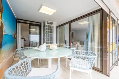 a dining room with a table and chairs at Luxurious Seaview Apartment with pool 5min Beach in Albufeira