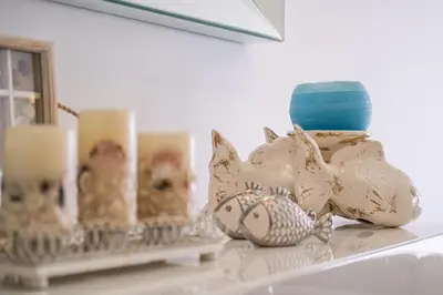 a shelf with a vase and candles on it at Luxurious Seaview Apartment with pool 5min Beach in Albufeira
