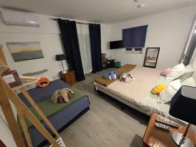 a bedroom with a bed with stuffed animals on it at Guest House Casa Ramos on the Strip in Albufeira