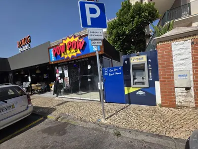 a parking sign in front of a mobil gas station at Guest House Casa Ramos on the Strip in Albufeira