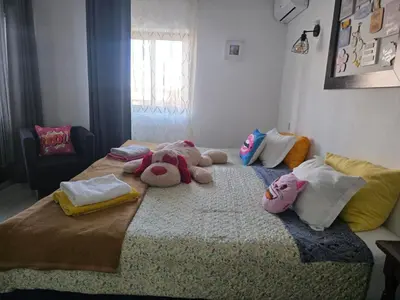 a room with two beds with stuffed animals on it at Guest House Casa Ramos on the Strip in Albufeira