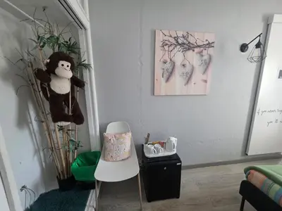 a living room with a stuffed animal and a chair at Guest House Casa Ramos on the Strip in Albufeira