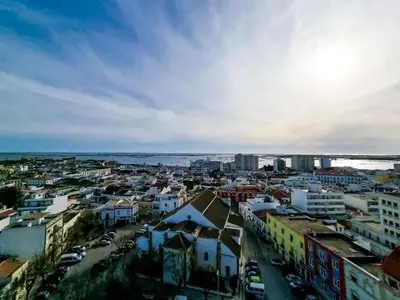 a view of a city with buildings and the ocean at FLH Faro Family Flat with Balcony in Faro