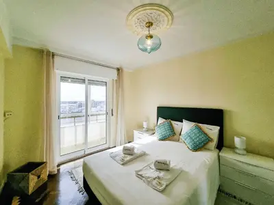 a bedroom with a bed with two plates on it at FLH Faro Family Flat with Balcony in Faro