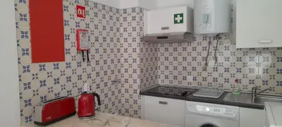 a kitchen with a sink and a red appliance at CASA IRINA Centro Cidade Albufeira in Albufeira