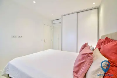 a bedroom with a white bed with red pillows at Vale Mangude A by MTPhomes in Albufeira