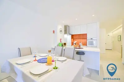 a kitchen with a white table with a white table cloth at Vale Mangude A by MTPhomes in Albufeira