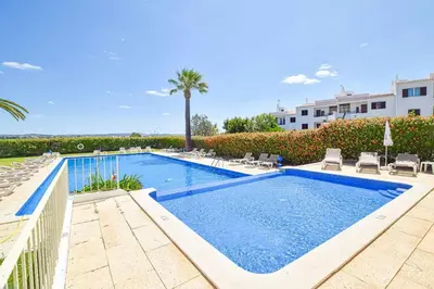 a white room with a kitchen and a table at Estúdio Solar A by MTPhomes in Albufeira