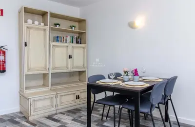 a dining room with a table and chairs at Aveiros Beach Apartment Ocean View - By Dalma Portuguesa in Albufeira