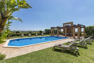 a villa with a swimming pool and a gazebo at Quinta Dionysus in Albufeira