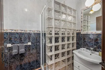a bathroom with a glass walled shower and a sink at Stunning Countryside Villa w Private Garden & Pool in Alte