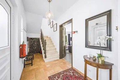 a hallway with white walls and a staircase with a mirror at Stunning Countryside Villa w Private Garden & Pool in Alte