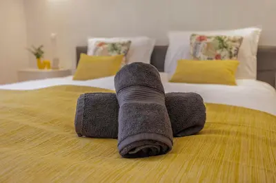 a rolled up towel on top of a bed at Stunning Countryside Villa w Private Garden & Pool in Alte