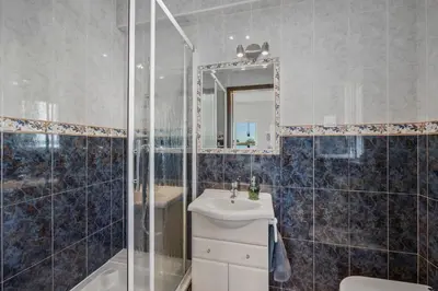 a bathroom with a sink and a shower at Stunning Countryside Villa w Private Garden & Pool in Alte