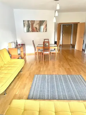 a living room with a couch and a table and chairs at Marina View Apartment in Albufeira