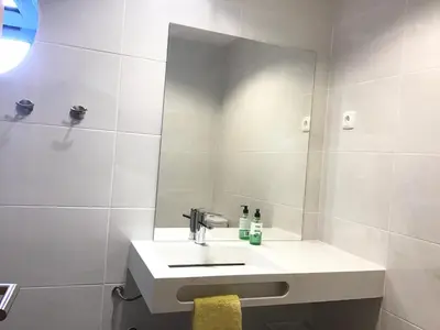 a bathroom with a sink and a mirror at Marina View Apartment in Albufeira