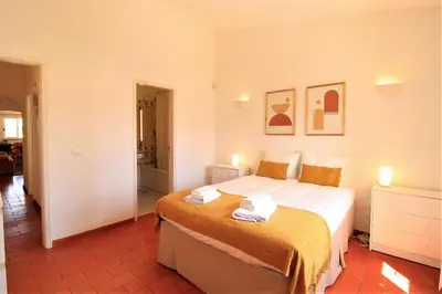 a bedroom with a bed with two towels on it at Vilamoura Concept Villa With Pool by Homing in Vilamoura