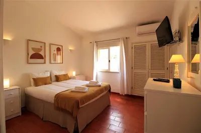 a bedroom with a large bed and a window at Vilamoura Concept Villa With Pool by Homing in Vilamoura
