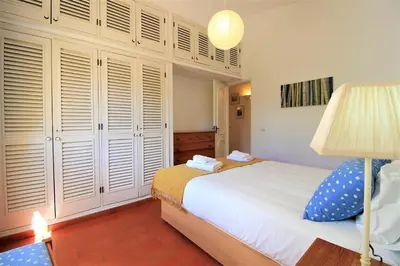 a bedroom with a bed and a lamp at Vilamoura Concept Villa With Pool by Homing in Vilamoura