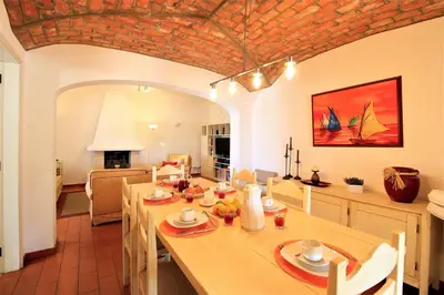 a kitchen and dining room with a table and chairs at Vilamoura Concept Villa With Pool by Homing in Vilamoura