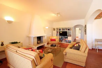 a living room with two couches and a fireplace at Vilamoura Concept Villa With Pool by Homing in Vilamoura