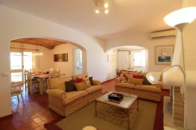 a living room with two couches and a table at Vilamoura Concept Villa With Pool by Homing in Vilamoura