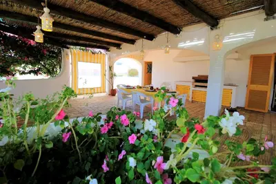 a living room with a table and some flowers at Vilamoura Concept Villa With Pool by Homing in Vilamoura
