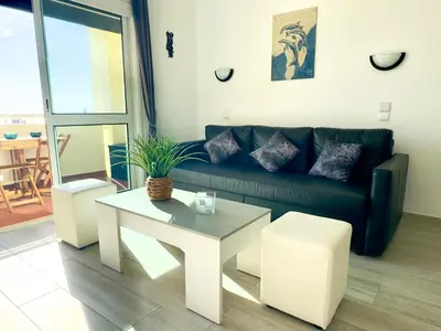 a living room with a couch and a table at Apartment Les 3 Dauphins in Albufeira in Albufeira