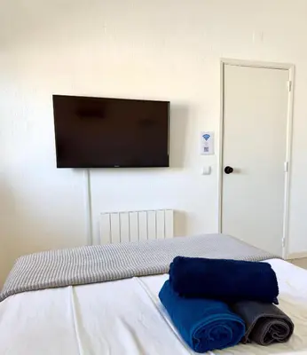 a bedroom with a bed with a flat screen tv on the wall at Apartment Les 3 Dauphins in Albufeira in Albufeira