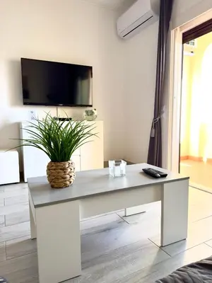 a living room with a table with a plant on it at Apartment Les 3 Dauphins in Albufeira in Albufeira
