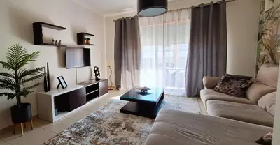 a living room with a couch and a table at Sul House in Albufeira