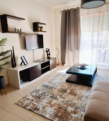 a living room with a couch and a coffee table at Sul House in Albufeira