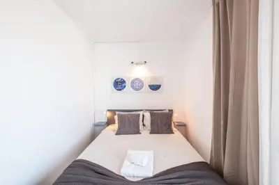 a bedroom with a bed in a room with at BeGuest Oceanic Rainbow Apt in Albufeira